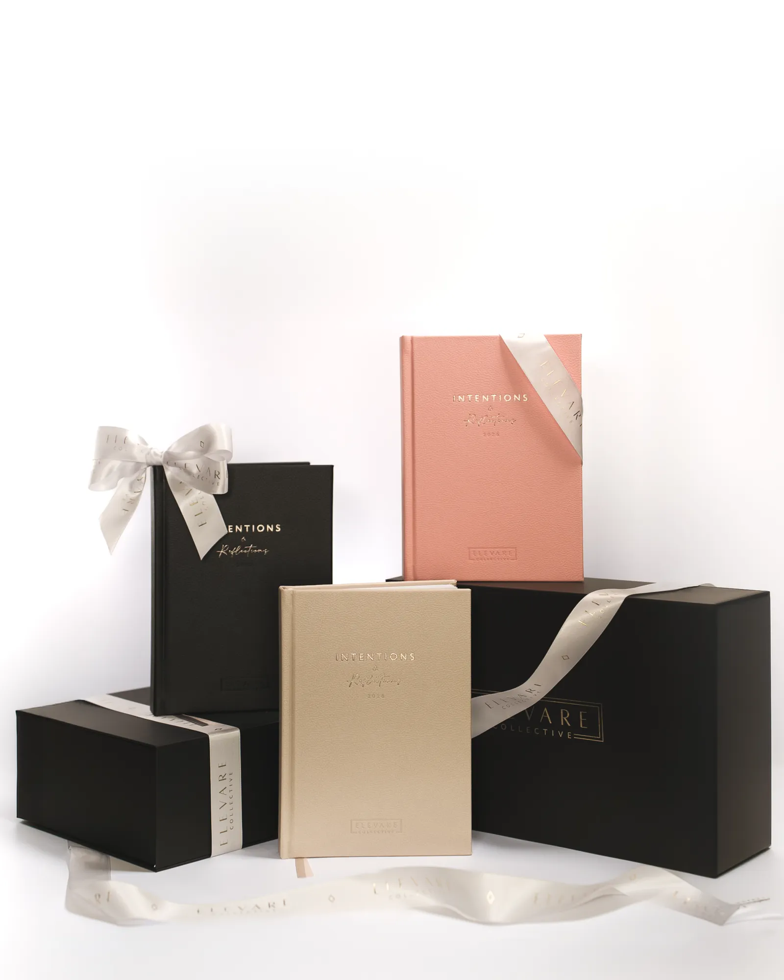 Elevare gift boxes and journals styled with ribbon on white