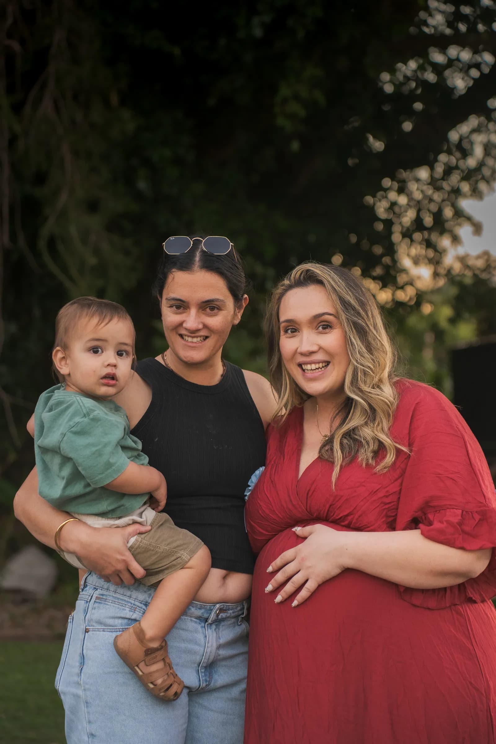 Two guests and a toddler standing with the mum to be