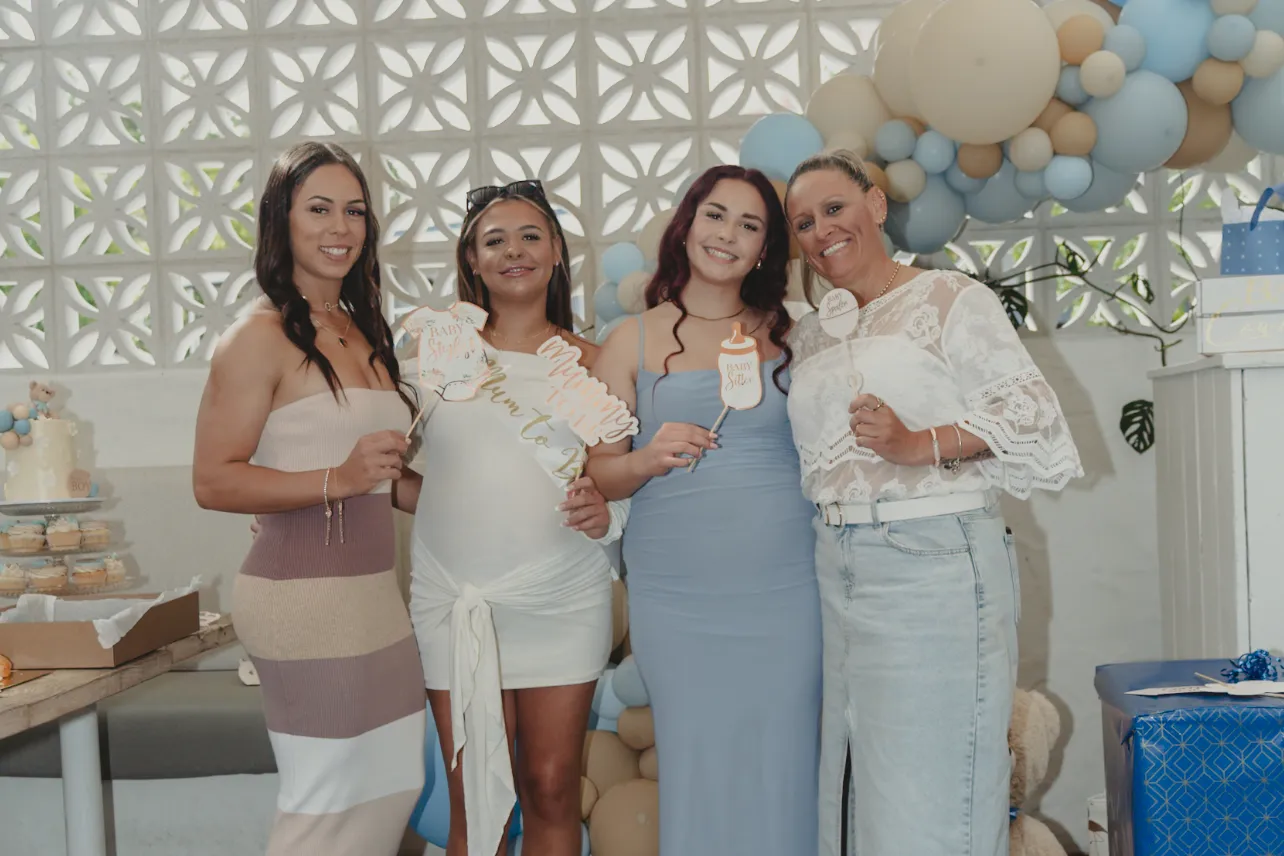Four guests photographed together in front of the balloon display