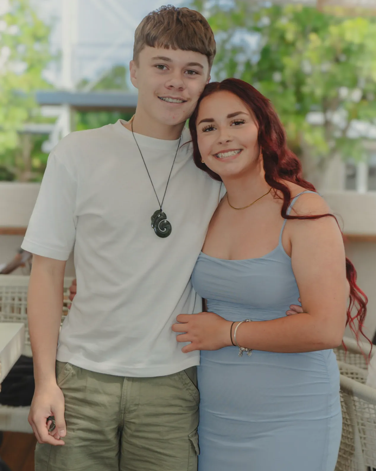 A young couple in front of the balloon display